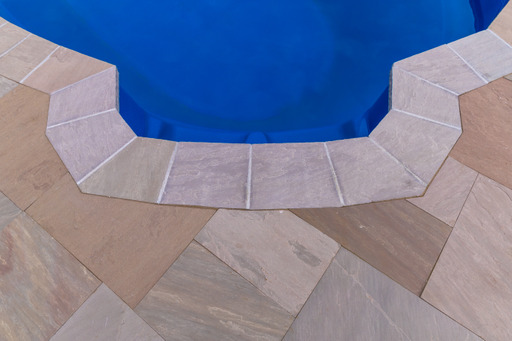 Coping around the steps of a pool