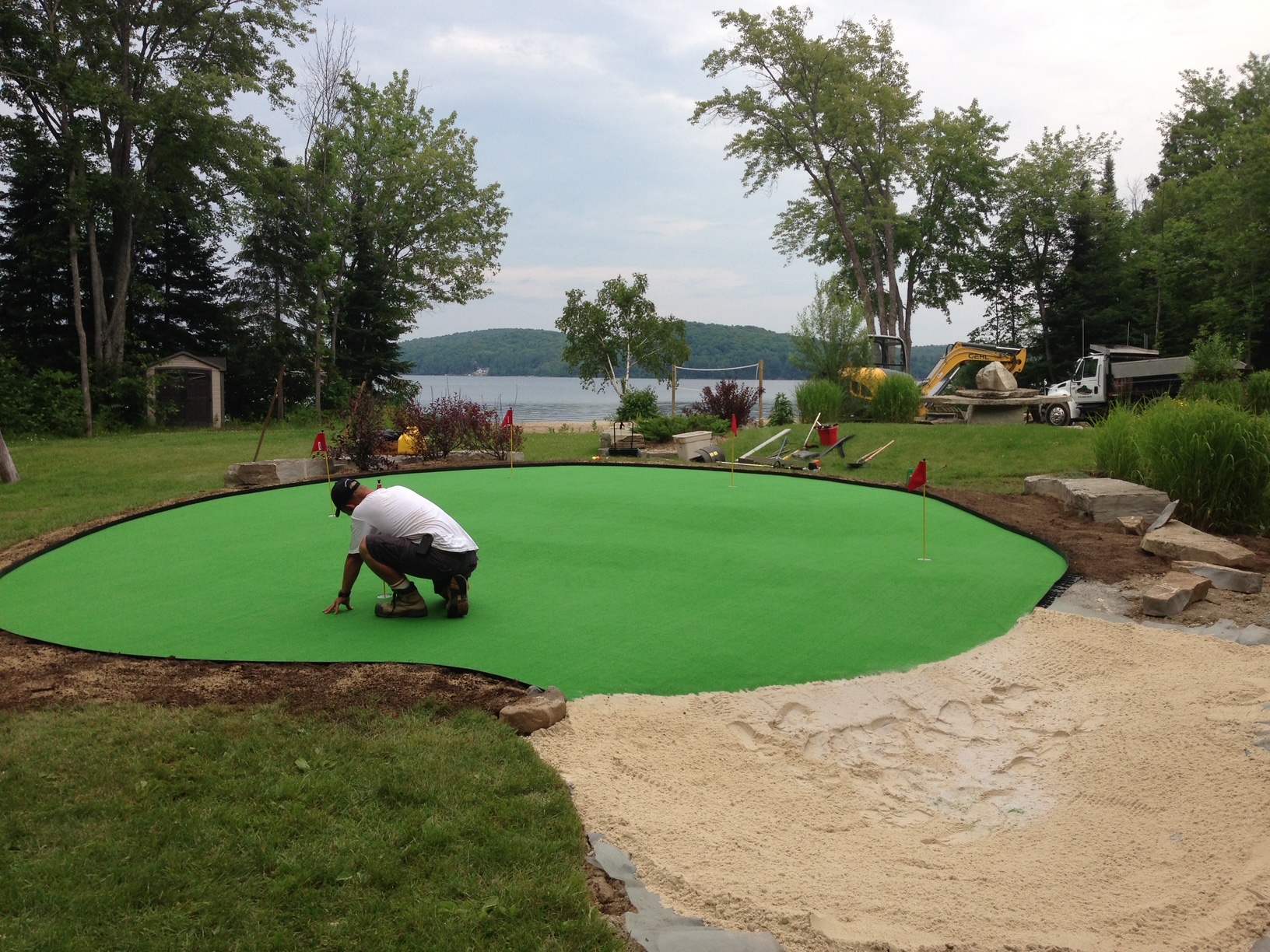 A custom putting green being installed in Muskoka