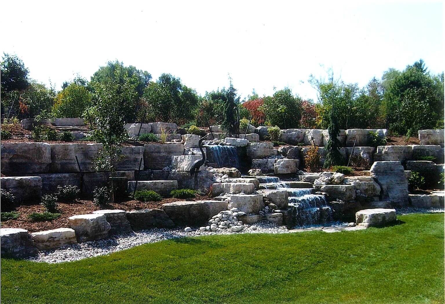 Evans's Residence in Elora with retaining walls, gardens and waterfall