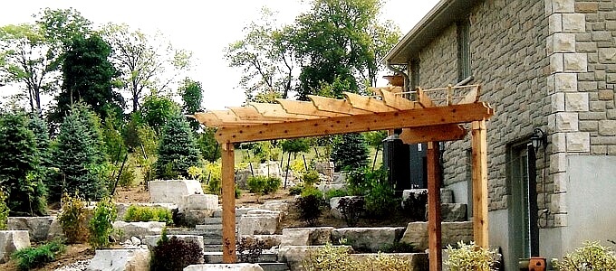 Evan's Residence Pergola in the foreground with a winding natural stone staircase