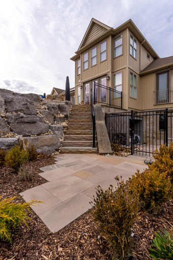 Natural stone steps and square cut flagstone patio